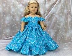 a doll wearing a blue dress with white flowers