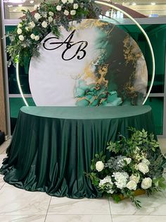 the table is set up with flowers and greenery