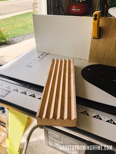 a piece of wood sitting on top of a table next to a ruler and other tools