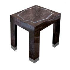 a wooden table with metal legs and a square design on the top that is made out of wood