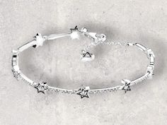 ✨ Sparkle and shine with our Shining Star Charm Bracelet! 🌟 This stunning piece features a dazzling cubic zirconia star charm on an adjustable chain, making it perfect for both women and men. Ideal for couples, this bracelet is a beautiful jewelry gift that adds a touch of elegance to any outfit. 💫🎁 Silver Star Bracelet, Stars Bracelet, Star Charm Bracelet, Chain Making, Chain For Women, Star Bracelet, Shining Star, Star Charms, Silver Stars