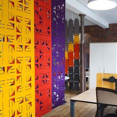 an office with colorful partitions on the wall