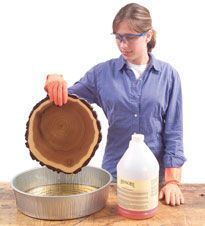 a woman is holding a pan with syrup in it and looking down at the lid