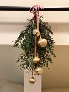 a bunch of bells hanging from a christmas tree with candy canes on it's end