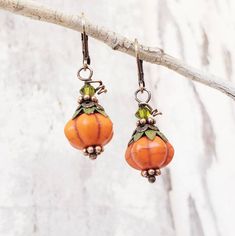 "These adorable little pumpkins will definitely bring you some Autumn cheer. These tangerine orange howlite stones are accented with genuine copper bead caps on top and bottom that resemble the stem of the pumpkin. Atop the copper caps sits a olive green sparkly Swarovski crystal. They measure 1 1/4\" in length from the top of the copper earwires. *Ready to ship in 3-5 days.* See these earrings in white pumpkins here: https://www.etsy.com/listing/873778151/pumpkin-earrings-white-howlite-fall?ref Orange Earrings For Fall Season Gift, Fall Orange Earrings As Gift, Pumpkin Accessories, Earrings 2024, Honey Bee Jewelry, Pumpkin Jewelry, Honey Bee Earrings, Autumn Earrings, Autumn Jewelry