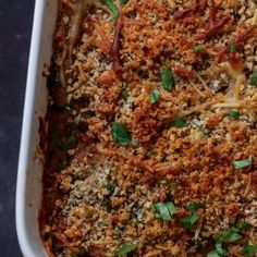 a casserole dish with meat, cheese and parmesan sprinkles