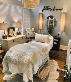 a bedroom with a bed, dressers and lamps in it's center area