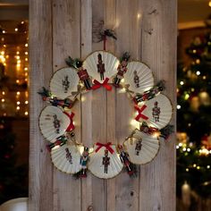 a christmas wreath hanging on the side of a wooden wall