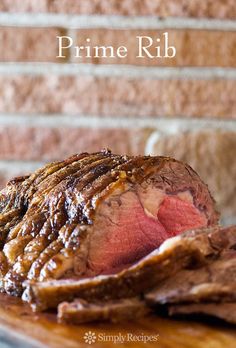 prime rib roast on a wooden cutting board with the words prime rib written above it