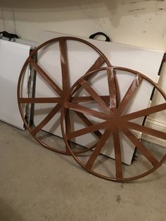 a white refrigerator freezer sitting next to a wooden wheel