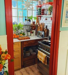 an open door leading into a kitchen with pots and pans on the stove top