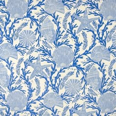 a blue and white wallpaper with seashells on it