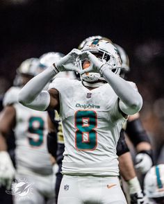 the miami dolphins players are warming up before their game