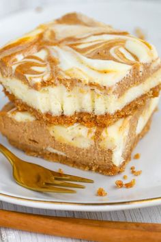 pumpkin cheesecake bars on a plate with a fork