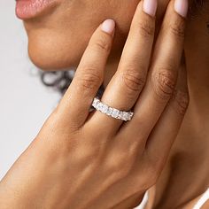 a close up of a person wearing a wedding ring with a diamond in the middle