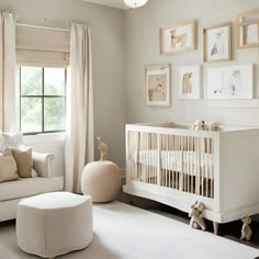 a baby's room with white furniture and pictures on the wall