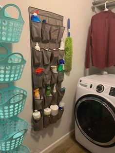 a washer and dryer in a bathroom next to a drying rack with cleaning products on it