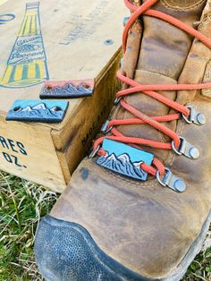 a pair of hiking boots sitting next to a box