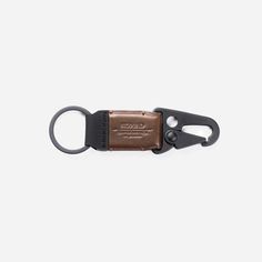 a brown and black leather keychain with a metal clip on it's side