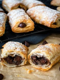 chocolate filled pastries sitting on top of a table