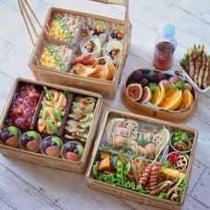 four bento boxes filled with different types of food