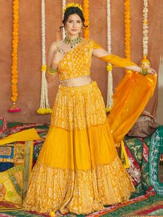 Enhance your beauty and make a statement with the Avantika Lehenga. This whimsical lehenga is designed to bring out your innate grace and grandeur. With its stunning mirror, pearl, stone, and embroidery work, this lehenga is perfect for women who want to shine at haldi ceremonies, special events, and festive occasions. Key Features: Color: Merigold Yellow Fabric & Work Style: Silk blouse with mirror, pearl, stone, and embroidery work Soft net lehenga with mirror, pearl, stone, and embroidery wor Chinon Anarkali Set For Reception Navratri, Chinon Anarkali Set For Reception And Navratri, Navratri Floor-length Palazzo Set With Dabka Work, Navratri Reception Anarkali Set, Dola Silk Anarkali Set With Mirror Work, Reception Choli With Gota Work In Chanderi, Unstitched Anarkali Choli For Designer Wear, Navratri Dola Silk Palazzo Set With Traditional Drape, Navratri Traditional Drape Dola Silk Palazzo Set