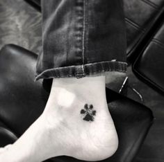 a person with a small paw tattoo on their foot