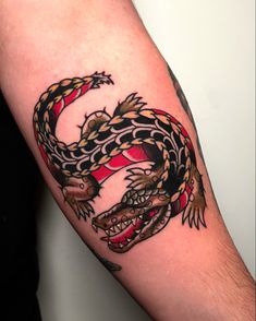 a tattoo with a dragon on the arm