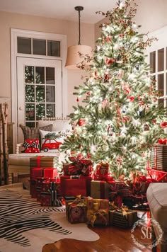 a decorated christmas tree with presents under it