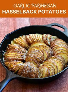 garlic parmesan hasselback potatoes in a cast iron skillet on a wooden table