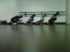 five people doing handstands in front of a bench with their feet on the ground