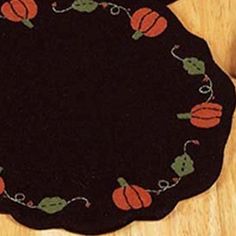 a black round rug with pumpkins on it