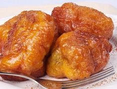 two pieces of fried food on a plate with a fork