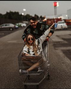 a man pushing a woman in a shopping cart