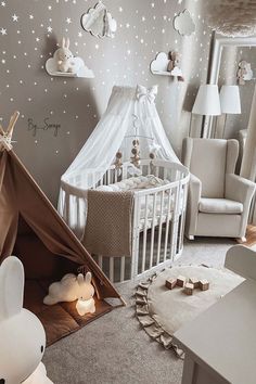 a baby's room with a teepee tent and stars on the wall