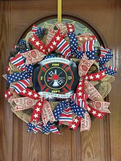 a fire department wreath with red, white and blue ribbons