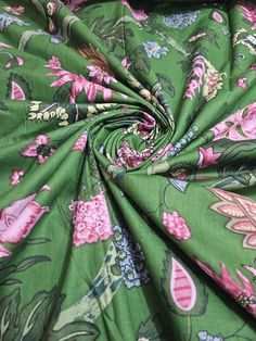 the fabric is green with pink flowers on it