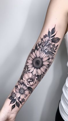 a woman with a sunflower tattoo on her arm and shoulder is holding out her hand