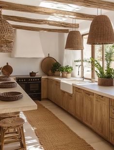 a kitchen filled with lots of counter top space and wooden cabinets next to a window