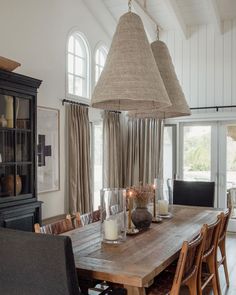 a dining room table with candles on it