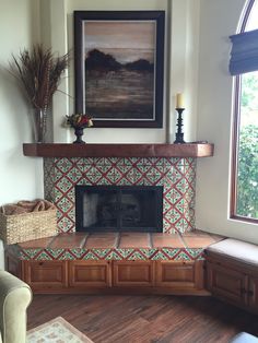 a living room with a fire place next to a window and a painting on the wall