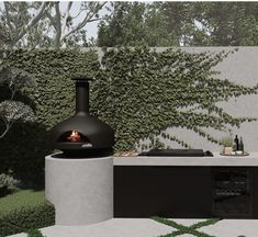 a modern outdoor kitchen with an oven and countertop in front of a wall covered with green plants