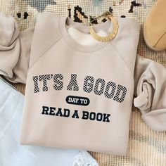 a sweatshirt with the words it's a good day to read a book on it