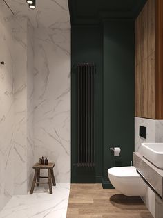 a modern bathroom with green walls and white marbled flooring, along with a wooden stool