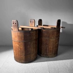 two old wooden buckets sitting next to each other