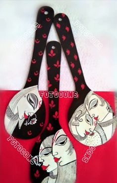 three black and white spoons with red hearts on them, one has an image of two women