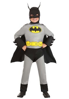 a little boy dressed in batman costume