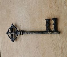 an old metal key on a wooden surface