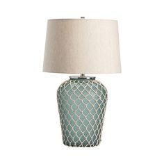 a blue lamp with a white shade on it and a beige lampshade behind it