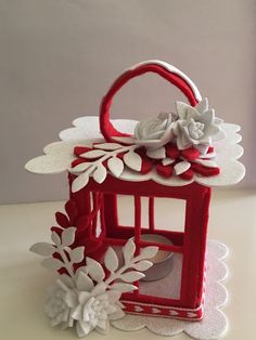 a small red and white box with flowers on it